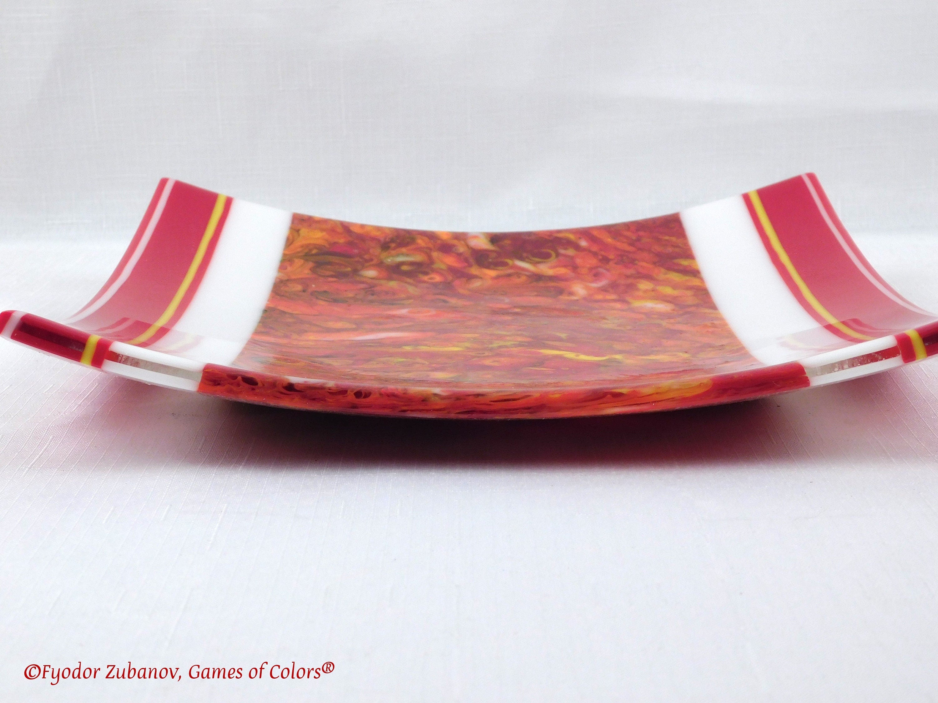 A decorative fused glass plate "Fire taming"