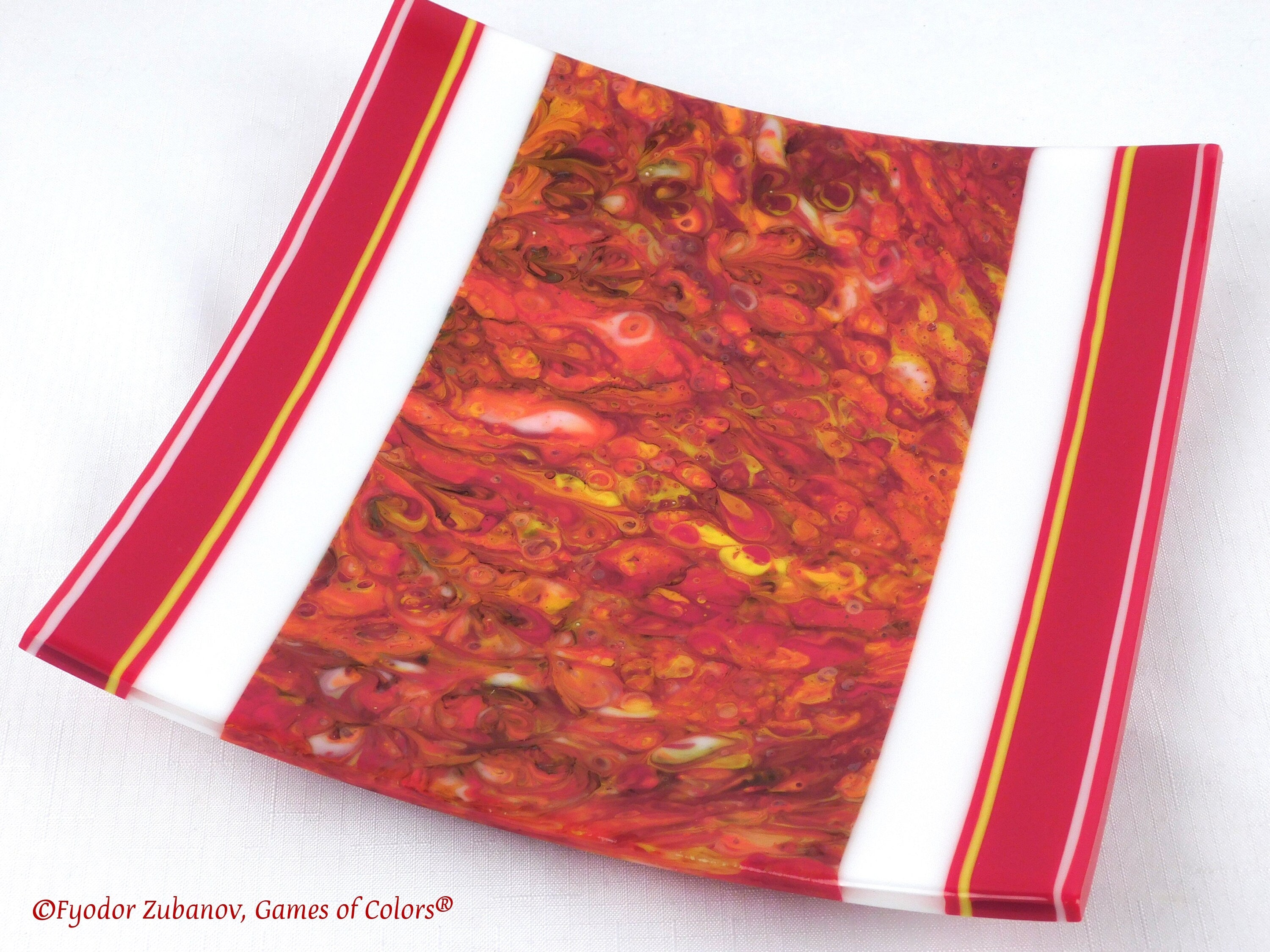 A decorative fused glass plate "Fire taming"