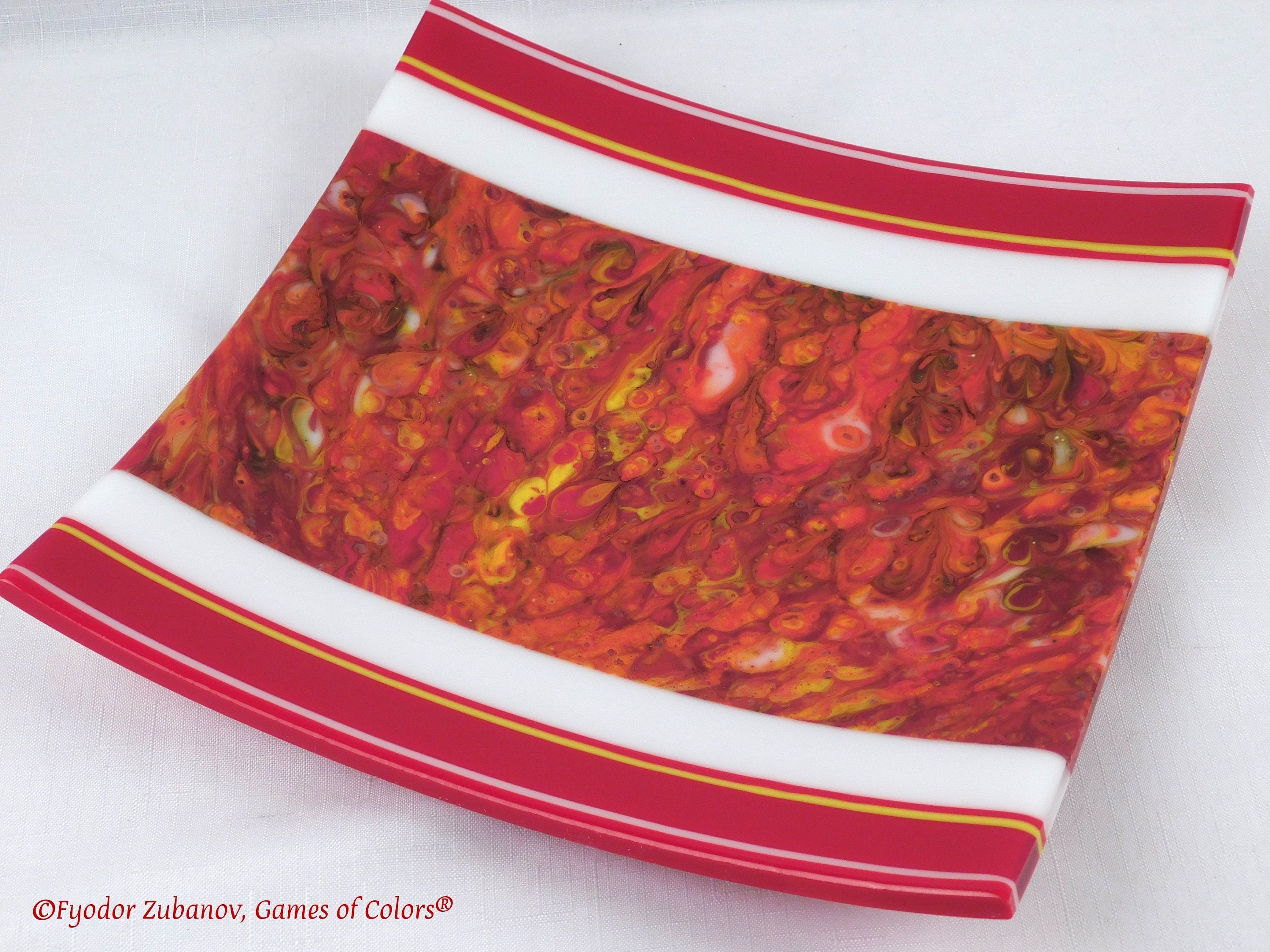 A decorative fused glass plate "Fire taming"