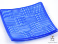 A square glass plate with checkered blue design.