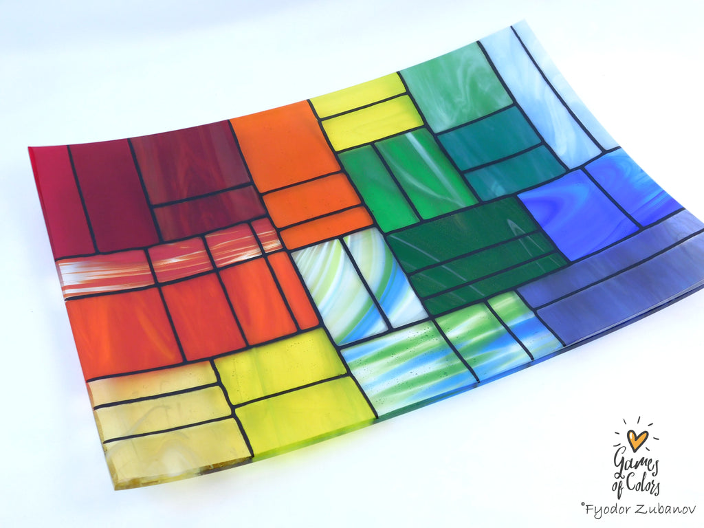 A colorful stained-glass-style rectangular plate or tray with a mosaic of multiple colors glass sections separated by dark grout lines, photographed on a white background. The plate is from the Gentle Color Mix collection. Branded as Fyodor Zubanov, Games of Colors