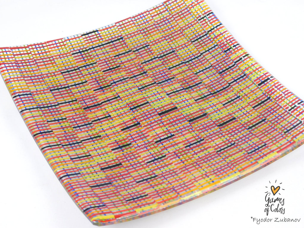 A square glass plate imitating fabric with a vibrant, multicolored geometric pattern featuring diagonal stripes and mesh-like textures in yellow, blue, green. and a watermark in the bottom right corner reads 'Fyodor Zubanov' and 'Games of Colors'.
