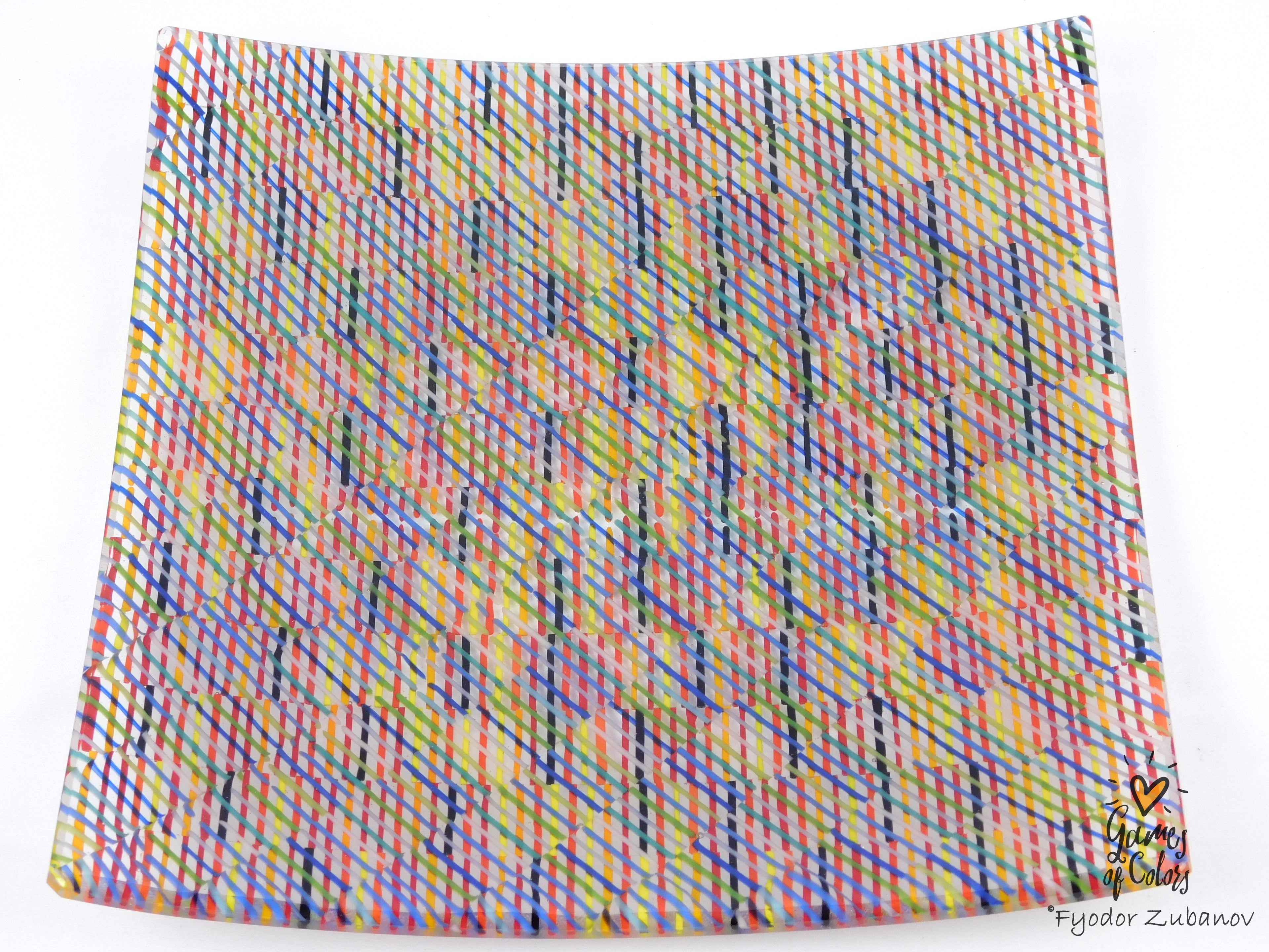 A square glass plate imitating fabric with a vibrant, multicolored geometric pattern featuring diagonal stripes and mesh-like textures in pink, yellow, blue, green.