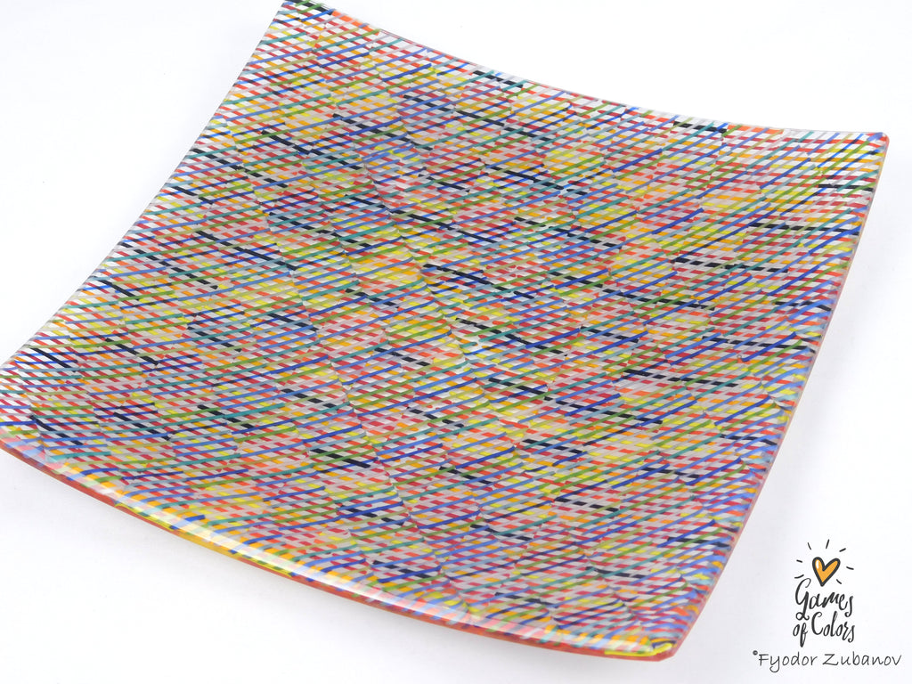 A square glass plate with rounded corners, featuring a vibrant multicolor pattern of intersecting wavy lines in pink, blue, yellow, green, and orange, photographed on a white background with a 'Gumay of Candy' watermark in the bottom right corner.