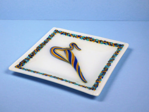 Decorative plate with a colorful abstract design on a blue background