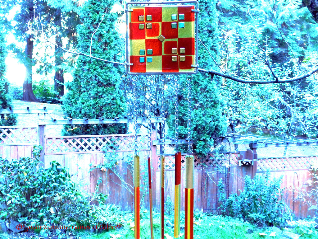 Wind chime with the main glass body surrounded by black frame and glass strips hanging on short chains